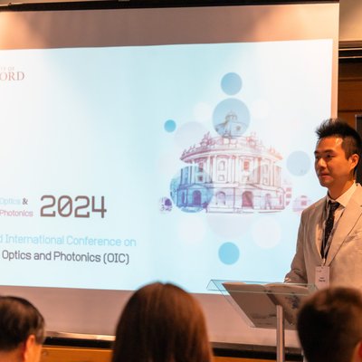 Dr Chao He addressing the Advanced Optics and Photonics Conference